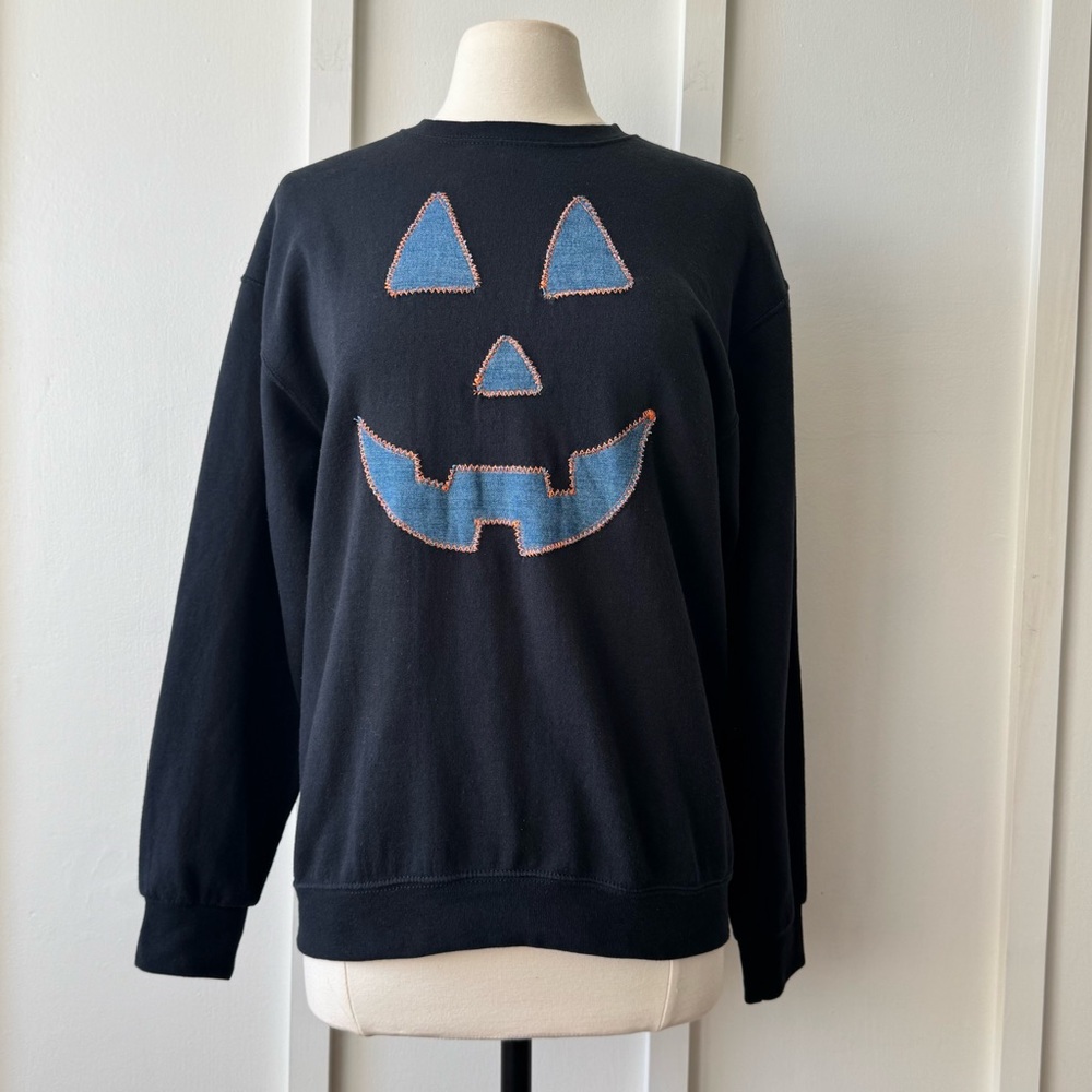Upcycled‎ Black Crewneck with Denim Jack-O’-Lantern Face